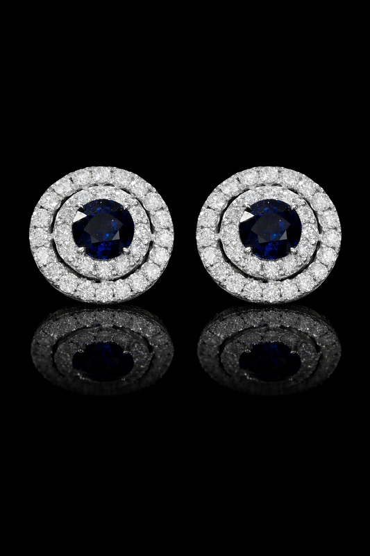 Natural round sapphire double halo stud earrings in 14K white gold with 0.65CT G-H SI diamonds – luxury Houston fine jewelry by Endless Diamonds.