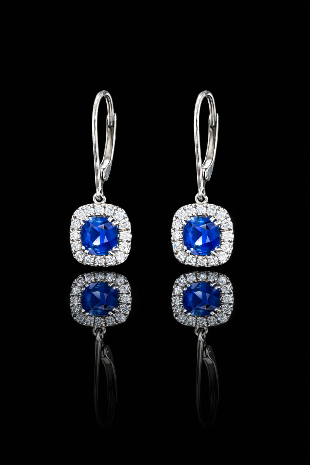 Natural cushion cut sapphire halo drop earrings in 14K white gold with 0.26CT G-H SI diamonds and lever-back closure – Houston fine jewelry by Endless Diamonds.