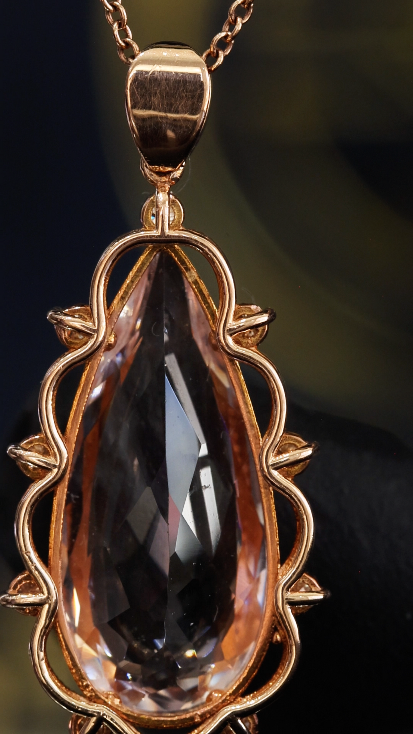 14K rose gold pear shaped morganite pendant with 5.88 carat center stone and 0.15 carat G-H SI diamond rope halo design
