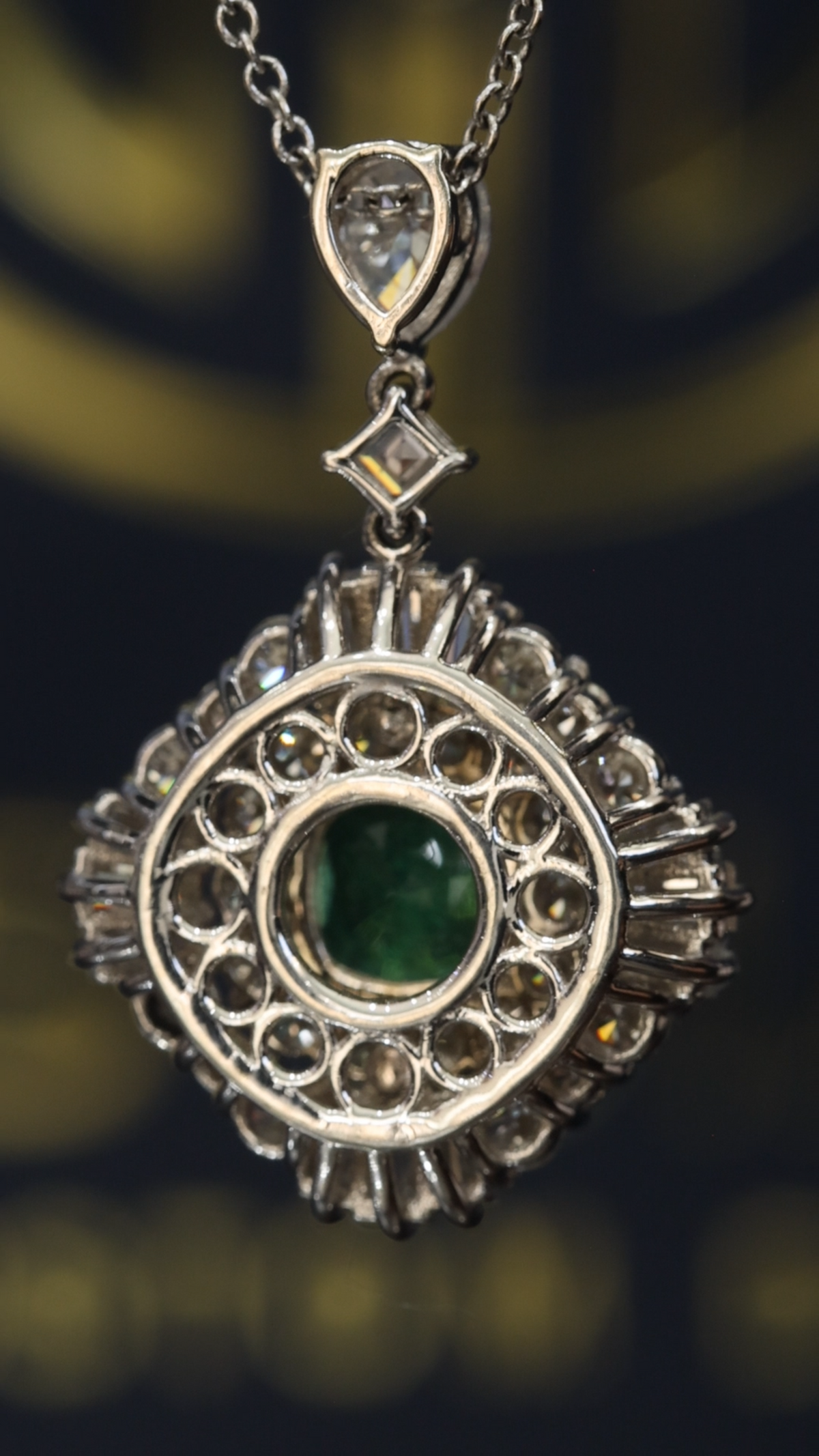 14K white gold emerald halo pendant with 1.00 carat cushion cut emerald and 2.01 carat G-H VS-SI diamond cluster setting