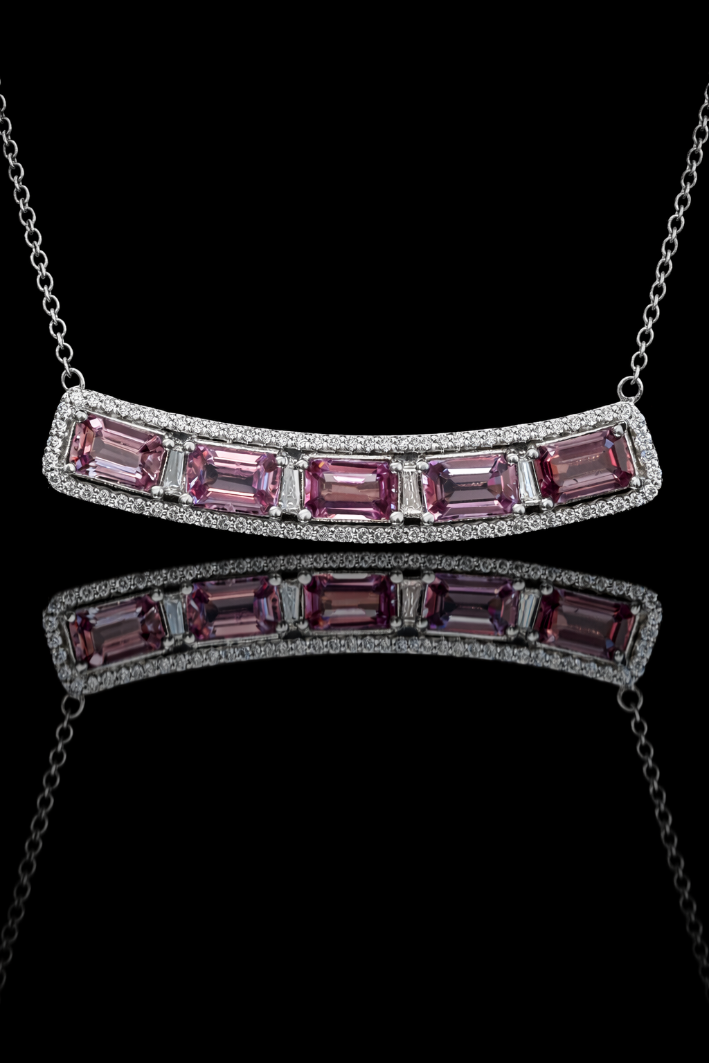 14K white gold curved pink sapphire bar necklace with 2.9 carat emerald cut sapphires and 0.5 carat diamond halo setting