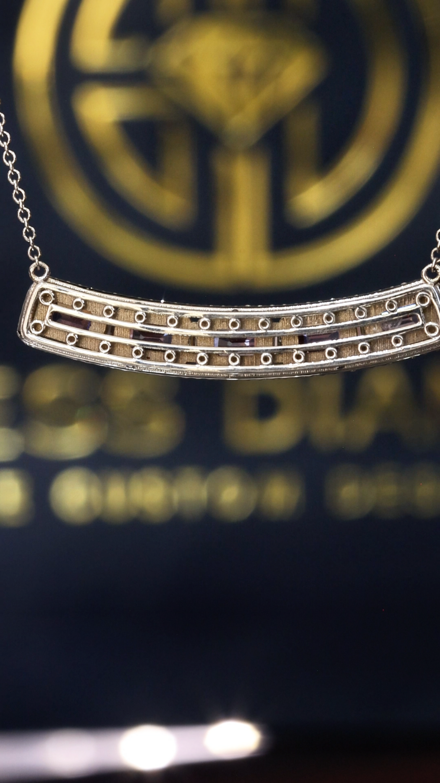 14K white gold curved pink sapphire bar necklace with 2.9 carat emerald cut sapphires and 0.5 carat diamond halo setting