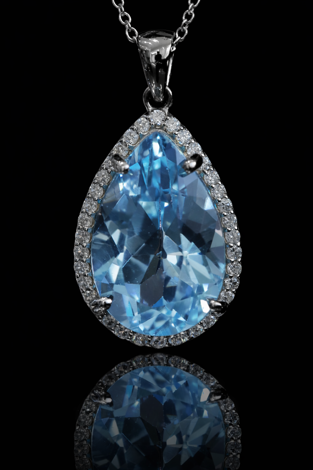 Pear shape blue topaz halo pendant in 14K white gold with 0.27 carat G-H SI diamond accents Houston jewelry store Endless Diamonds