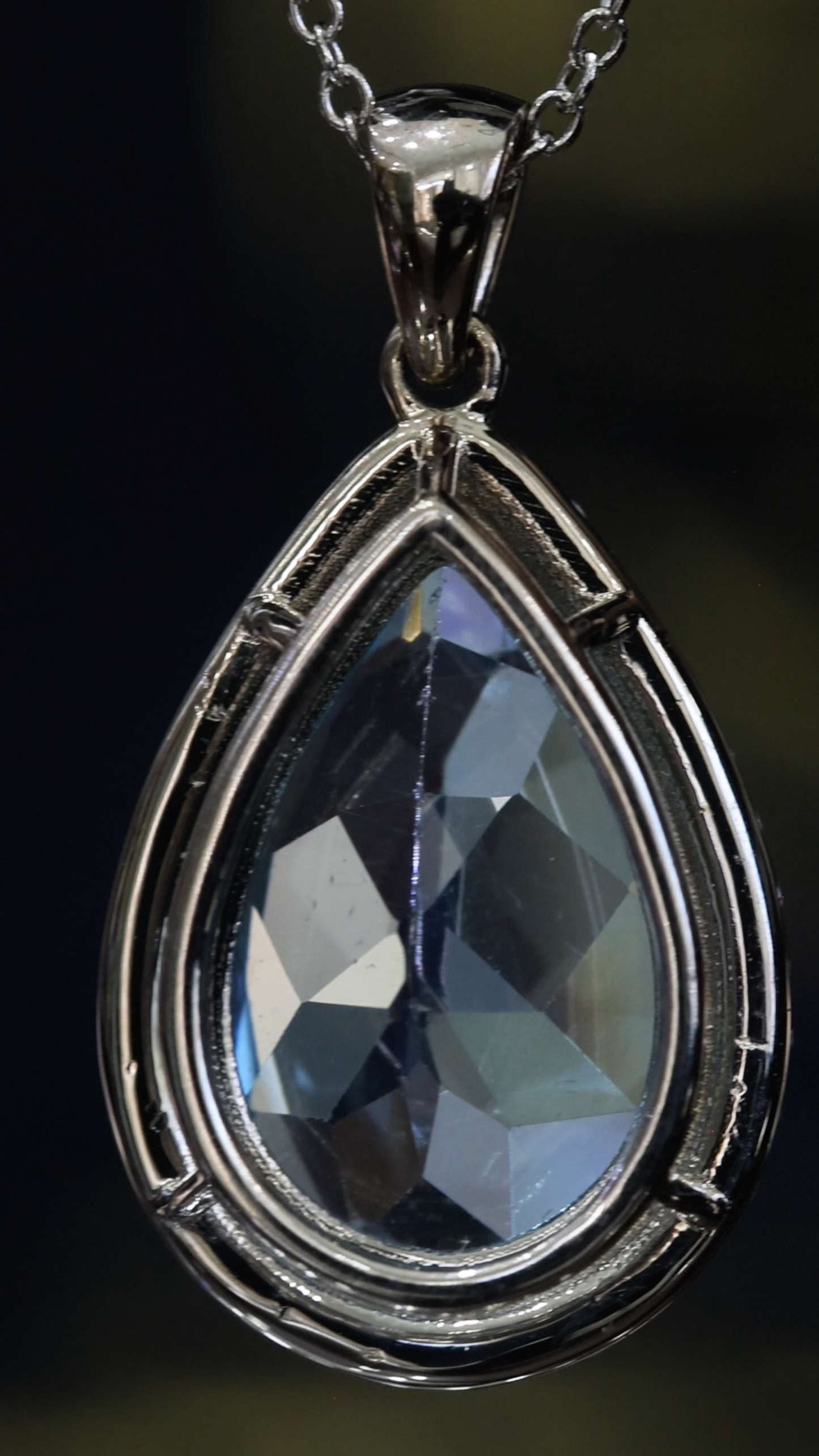 Pear shape blue topaz halo pendant in 14K white gold with 0.27 carat G-H SI diamond accents Houston jewelry store Endless Diamonds