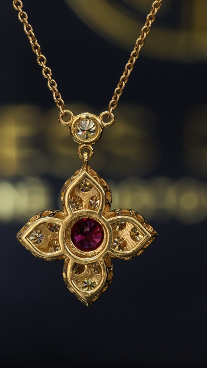 14K yellow gold ruby floral pendant with 0.80 carat fancy yellow diamonds and bezel-set ruby center with diamond station chain