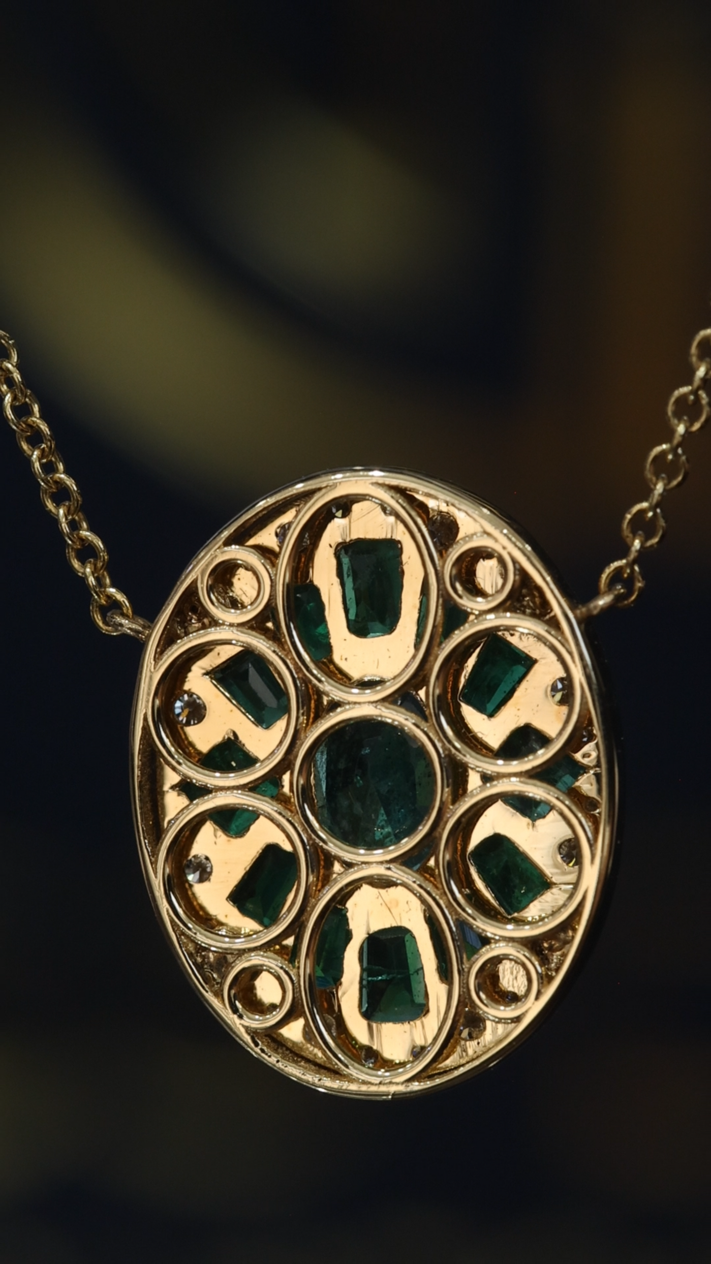 14K yellow gold emerald cluster halo pendant with 1.00 carat oval emerald and 0.20 carat G-H SI diamond frame
