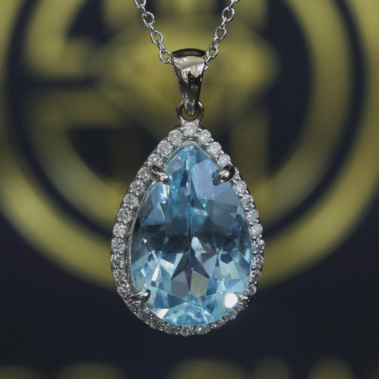 Pear shape blue topaz halo pendant in 14K white gold with 0.27 carat G-H SI diamond accents Houston jewelry store Endless Diamonds