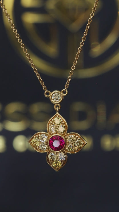 14K yellow gold ruby floral pendant with 0.80 carat fancy yellow diamonds and bezel-set ruby center with diamond station chain