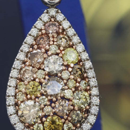 Fancy yellow diamond teardrop halo drop earrings in 14K white gold with 5.49CT VS–SI natural colored diamonds – luxury Houston fine jewelry by Endless Diamonds.