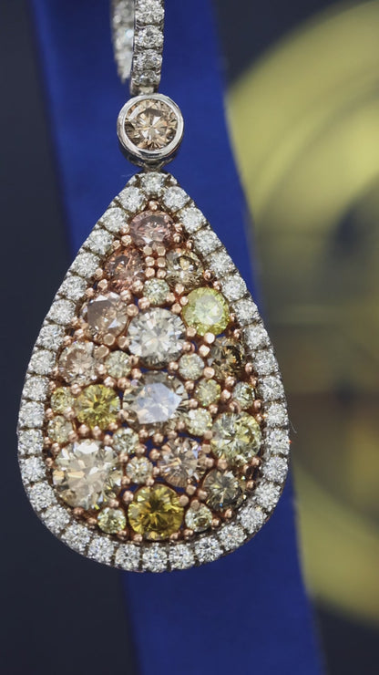 Fancy yellow diamond teardrop halo drop earrings in 14K white gold with 5.49CT VS–SI natural colored diamonds – luxury Houston fine jewelry by Endless Diamonds.