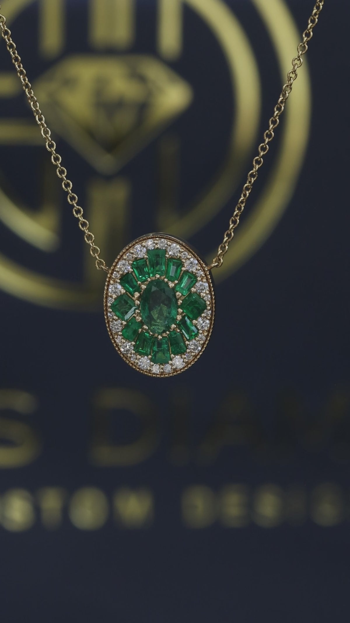 14K yellow gold emerald cluster halo pendant with 1.00 carat oval emerald and 0.20 carat G-H SI diamond frame